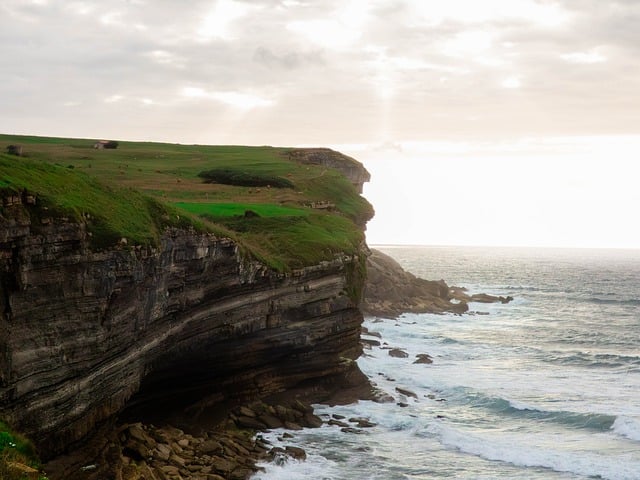 sea cliffs, ocean waves, coastal landscape, green fields, cloudy sky, dramatic landscape, rocky coast, natural scenery, ocean waters, coastal drama, sunrise, natural beauty, natural landscape, cliffs and waves, coastal path, moody view, horizontal frame, moody atmosphere, nature, natural retreat - 4K 8K wallpaper background by g5fighter | Pix8K